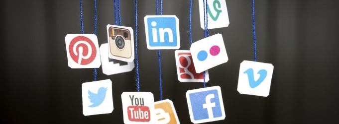 Popular social media website logos printed on paper and hanging
